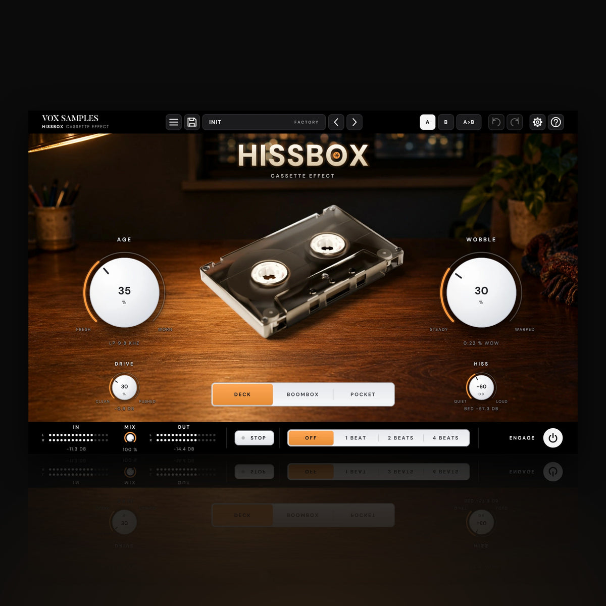 Hissbox Cassette Effect by Vox Samples, the cassette plugin: a clear smoke cassette on a walnut desk at night under a brass lamp, the HISSBOX logo, and two big pearl-white knobs, AGE and WOBBLE.