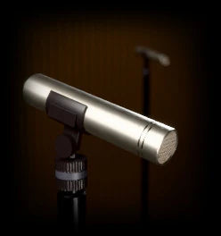 Air Max 2, AURA: a small pencil condenser microphone on a stand in a wood-panelled room