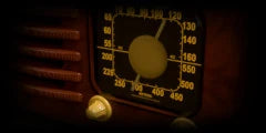 LoFi Pro 2, AM RADIO: the lit round dial of a walnut table radio