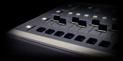LoFi Pro 2, 12-BIT SAMPLER: close on a grey tabletop drum sampler’s faders and pads