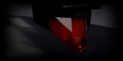 LoFi Pro 2, NOISE: a red stylus cartridge low over a dusty record