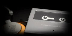 LoFi Pro 2, PORTABLE CASSETTE: a silver personal cassette player beside orange foam headphone pads