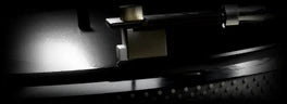 Reverse King 3, VINYL: a turntable’s tonearm and stylus on a spinning record